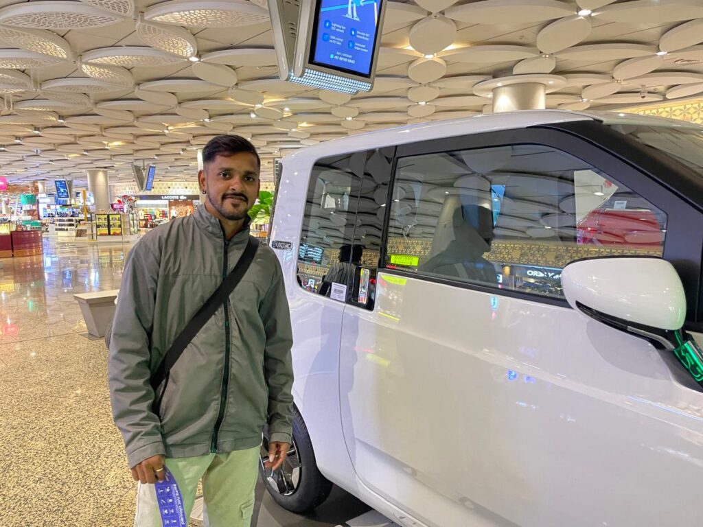 Prasad Near Car at Airport_SKP